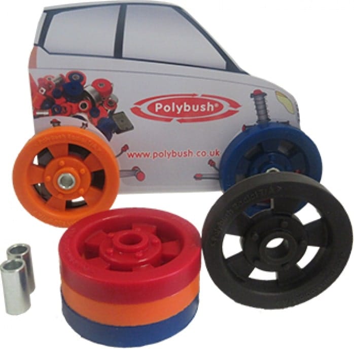 Promotional model car with the polybush logo and website, accompanied by various colourful car suspension bushings and components arranged around it.