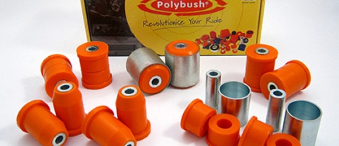 A collection of orange polybush car suspension bushings and metal parts displayed in front of their packaging box with the UK flag and the text "revolutionise your ride".Since both texts are in English, there isn't any translation to be made. However, re-phrasing to sound more British can be considered a form of "translation":A collection of orange polybush vehicle suspension bushings and metal components proudly presented in front of their packaging box, adorned with the UK flag and emblazoned with the text "revolutionise your drive".