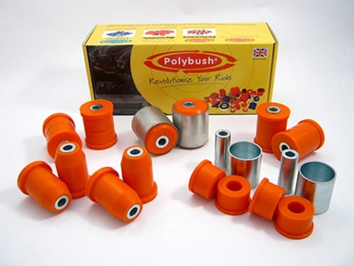 A collection of orange polybush car suspension bushings and metal parts displayed in front of their packaging box with the UK flag and the text "revolutionise your ride".Since both texts are in English, there isn't any translation to be made. However, re-phrasing to sound more British can be considered a form of "translation":A collection of orange polybush vehicle suspension bushings and metal components proudly presented in front of their packaging box, adorned with the UK flag and emblazoned with the text "revolutionise your drive".