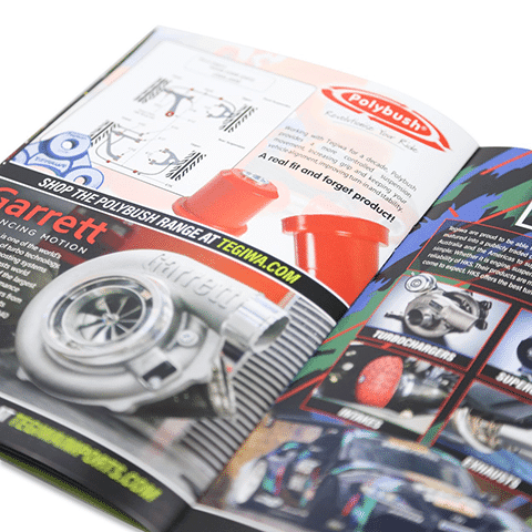 Open magazine showcasing various car parts including a turbocharger, lubricant sprays, and other car accessories. The pages are glossy and feature vibrant images with text descriptions.